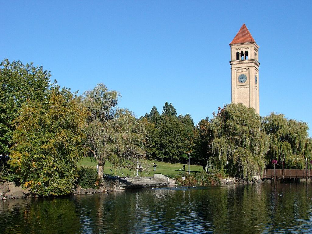 The 1902 clock tower rising over the river and the park's paths.